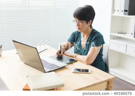 Business, web design and graphic art concept - middle-aged woman using pan sketch device Business, web design and graphic art concept - middle-aged woman using pan sketch device 46586078