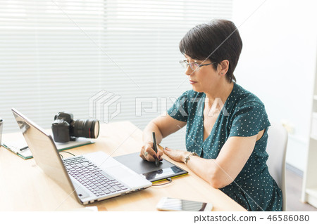 Business, web design and graphic art concept - middle-aged woman using pan sketch device Business, web design and graphic art concept - middle-aged woman using pan sketch device 46586080