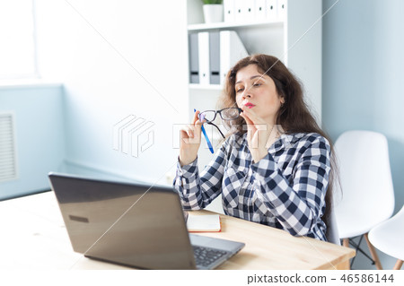 Office, graphic designer and people concept - Thoughtful woman is working at the office with laptop 46586144