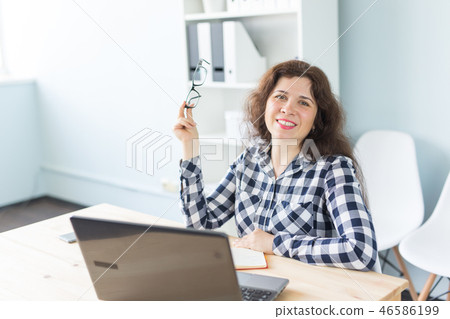 Coworking, graphic designer and business people concept - woman is working at the office with laptop Coworking, graphic designer and business people concept - woman is working at the office with laptop 46586199