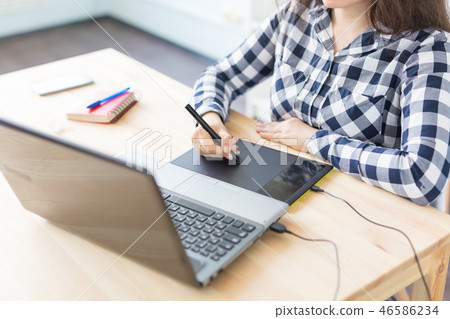 Close-up of female hands using digital graphic tablet at modern office 46586234