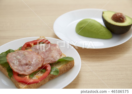 Avocado on white plate Healthy Avocado on white plate Healthy 46586575