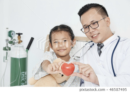 Young male doctor pediatrician checking girl Young male doctor pediatrician checking girl 46587495
