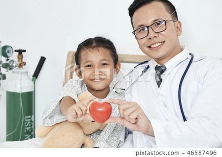Young male doctor pediatrician checking girl Young male doctor pediatrician checking girl 46587496