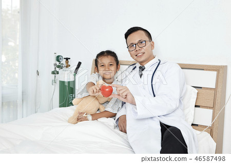 Young male doctor pediatrician checking girl Young male doctor pediatrician checking girl 46587498