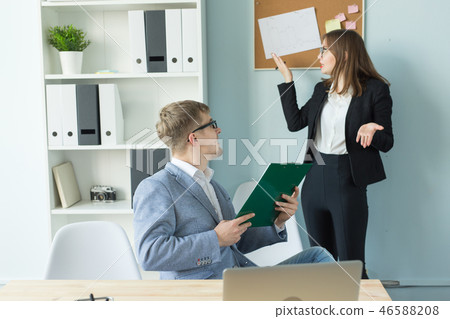 Business, team work and people concept - woman and man are discussing their project together in 46588208