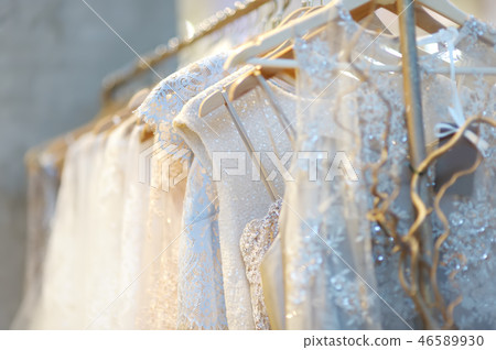 Few beautiful wedding dresses on a hanger. 46589930