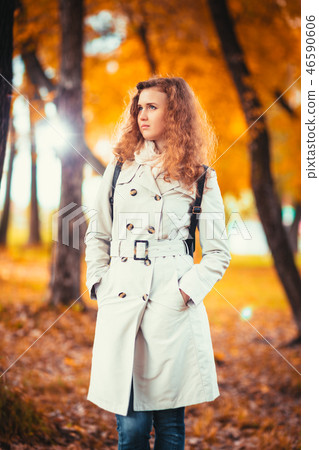 young girl in a light coat on the of autumn park 46590606