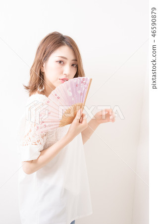A woman with a fan 46590879