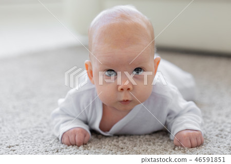 Childhood, babyhood and people concept - little baby boy or girl crawling on floor at home Childhood, babyhood and people concept - little baby boy or girl crawling on floor at home 46591851