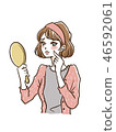 A woman looking at a mirror 46592061
