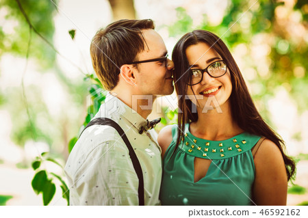 Beautiful young couple on the park background Beautiful young couple on the park background 46592162