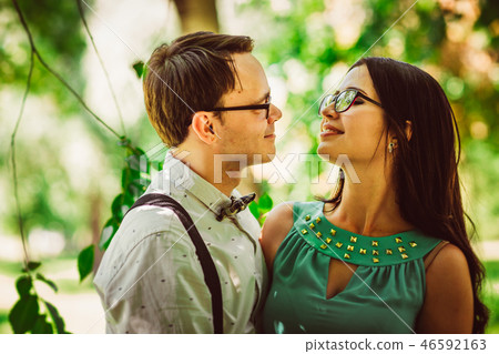 Beautiful young couple on the park background Beautiful young couple on the park background 46592163