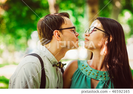 Beautiful young couple on the park background Beautiful young couple on the park background 46592165