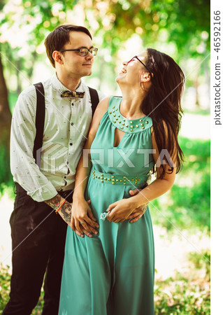 Beautiful young couple on the park background Beautiful young couple on the park background 46592166