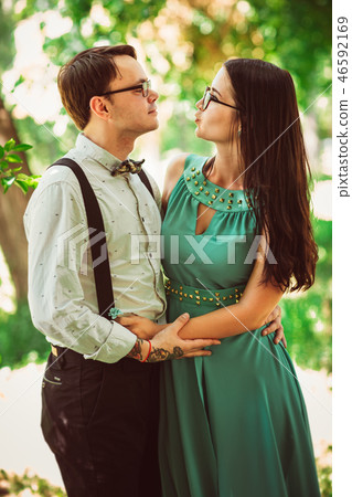 Beautiful young couple on the park background Beautiful young couple on the park background 46592169