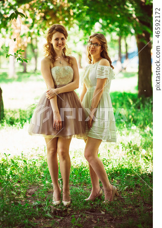 Two beautiful girlfriends on a plant background 46592172