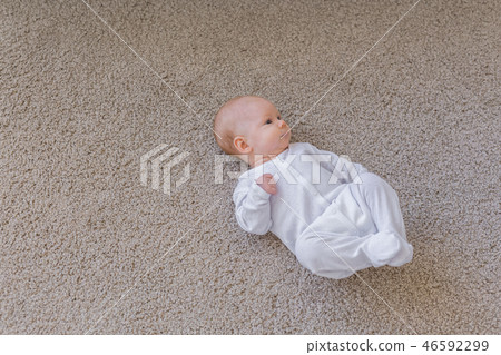 Baby, infant and childhood concept - Top view of the child on the floor with copy space 46592299