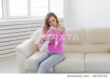 Childhood, motherhood, infant concept - happy mother holding her baby 46592539