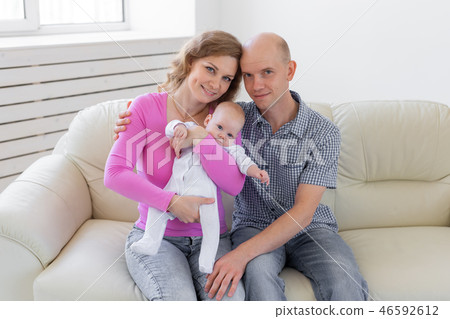 Childgood, parenthood, people concept - baby on the hands of parents on a white background. 46592612