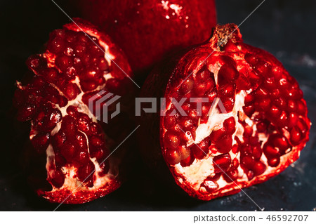 red sliced pomegranate on a blue abstraction 46592707