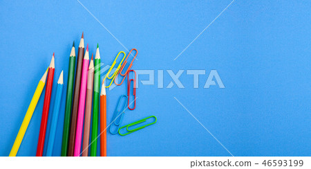 Office supply, Color pencils, paper clips on blue Office supply, Color pencils, paper clips on blue 46593199