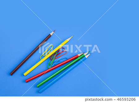 Office supply pencil paper clip on blue background 46593206