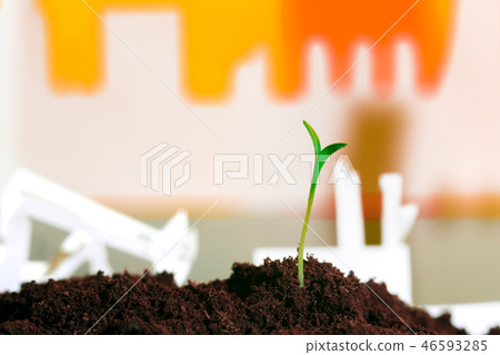 Young green plant in soil opposite factory Young green plant in soil opposite factory 46593285