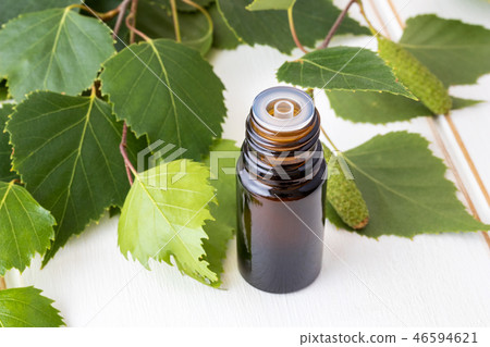 A bottle of birch essential oil and birch branches 46594621