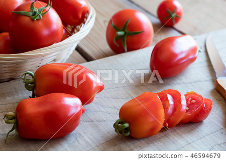 Slicing San Marzano tomatoes on a cutting board 46594679