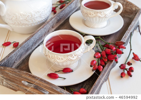 Rose hip tea in white cups with fresh rose hips 46594992