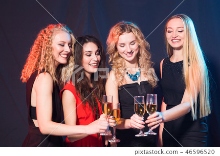 Party, holidays, celebration and nightlife concept - smiling female friends with glasses of Party, holidays, celebration and nightlife concept - smiling female friends with glasses of 46596520