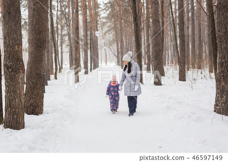 Motherhood, children and nature concept - Attractive young woman and adorable child walking in park Motherhood, children and nature concept - Attractive young woman and adorable child walking in park 46597149
