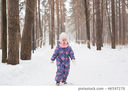 Children, winter and nature concept - Close up of adorable kid playing with snow in the park Children, winter and nature concept - Close up of adorable kid playing with snow in the park 46597278