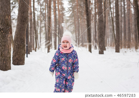 Children and nature concept - Adorable baby girl walking in winter park Children and nature concept - Adorable baby girl walking in winter park 46597283