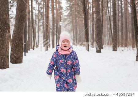 Children, winter and nature concept - Close up of adorable kid playing with snow in the park Children, winter and nature concept - Close up of adorable kid playing with snow in the park 46597284