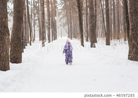 Childhood and children concept - baby girl walk in the winter outdoors Childhood and children concept - baby girl walk in the winter outdoors 46597285