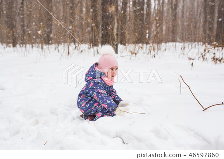 Family, children and nature concept - Beautiful little child girl have fun in winter park 46597860