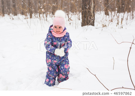 Children and nature concept - Adorable baby girl walking in winter park 46597862