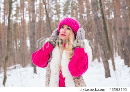 Fashion and people concept - Lovely young woman in warm jacket in winter park Fashion and people concept - Lovely young woman in warm jacket in winter park 46598593