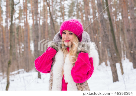 Beauty, fashion and people concept - Attractive blond woman standing in pink hat and sweaters in Beauty, fashion and people concept - Attractive blond woman standing in pink hat and sweaters in 46598594
