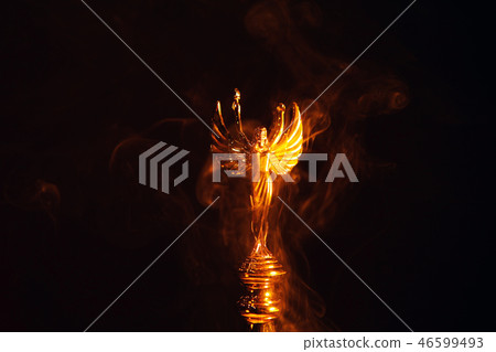 gold angel statue smoke dark background  46599493