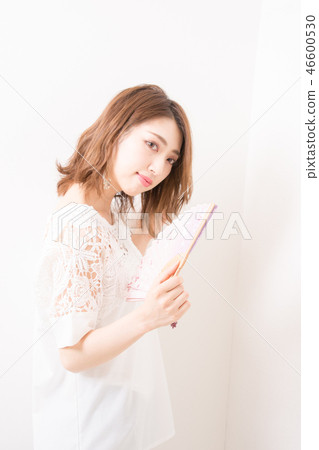 A woman with a fan 46600530