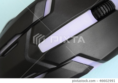 Closeup of a black gaming optical mouse on a blue Closeup of a black gaming optical mouse on a blue 46602991