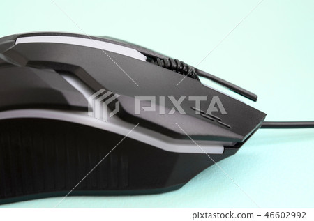 Closeup of a black gaming optical mouse on a blue Closeup of a black gaming optical mouse on a blue 46602992