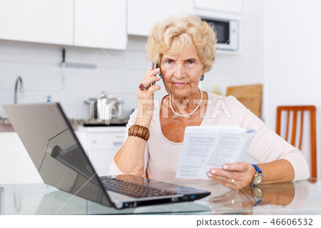 Woman talking on phone, using laptop Woman talking on phone, using laptop 46606532