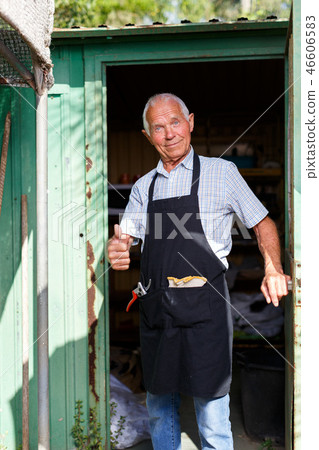 Happy man in doorway of garden shed 46606583