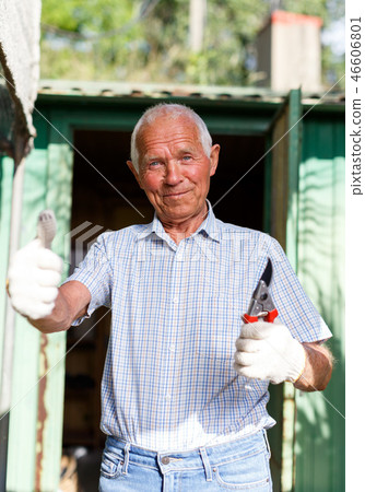 Cheerful gardener near garden shed Cheerful gardener near garden shed 46606801