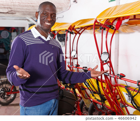 Glad driver of pedicab offering touristic tour 46606942