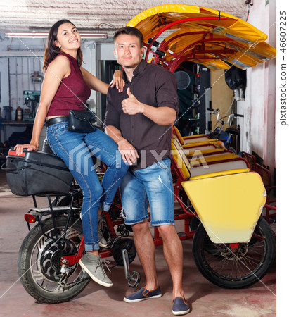 Cheerful girl with boyfriend wanting to hire touristic trishaw for urban trip 46607225